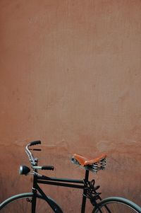 Close-up of bicycle against wall