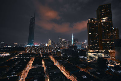 High angle view of illuminated cityscape against sky at night