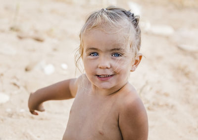Portrait of cute shirtless girl at beach