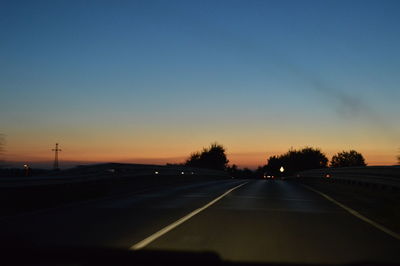 Cars on road at sunset