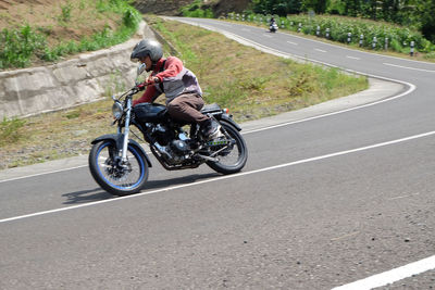 Man riding motorcycle on road