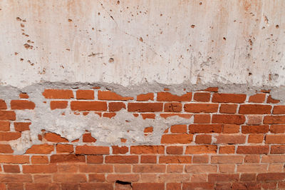 Full frame shot of peeled off brick wall