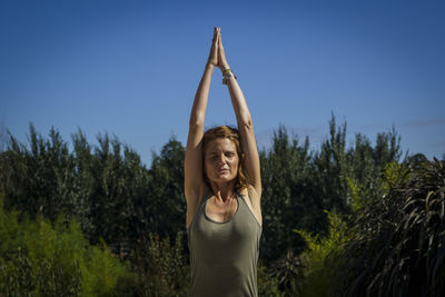 Rear view of woman standing against clear sky