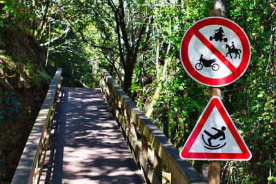 Road sign by trees