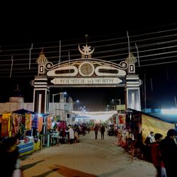 People at illuminated city at night