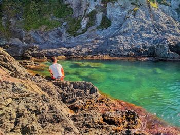 Full length of man on rocks at shore