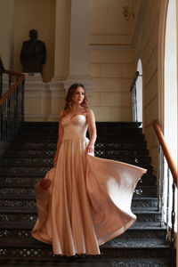 Young woman standing on staircase