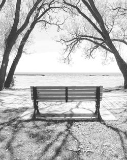 Empty bench by sea