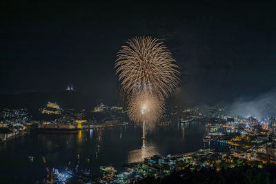 Firework display over city at night