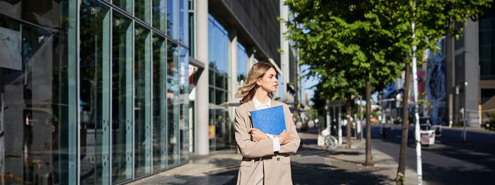 Rear view of woman standing in city