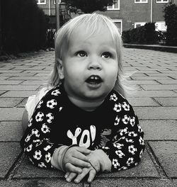 Close-up of cute boy lying on walkway