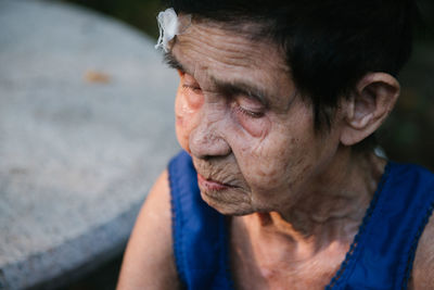 Woman with injured forehead outdoors