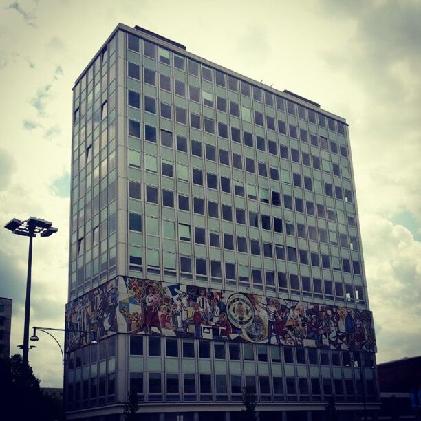 architecture, building exterior, built structure, low angle view, sky, modern, city, office building, cloud - sky, tall - high, glass - material, skyscraper, building, tower, cloud, city life, cloudy, reflection, window, capital cities