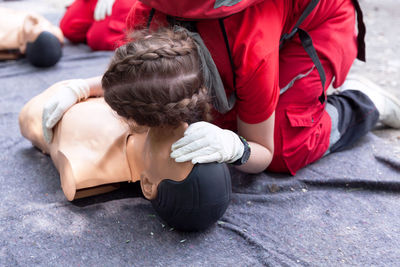 Low section of person performing cpr on dummy