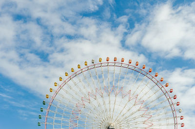 Low angle view of ferris wheel against sky