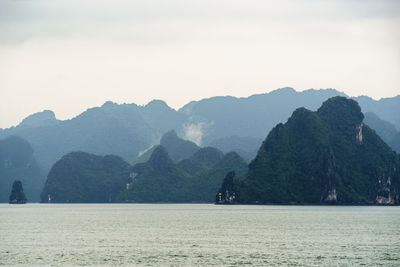 Scenic view of mountains in halong bay against clear sky