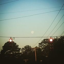 Low angle view of illuminated street light against sky