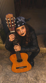 Teenage woman with guitar