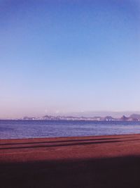 Distant view of suspension bridge over sea