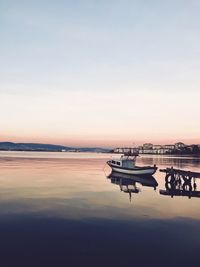 Boats in marina at sunset