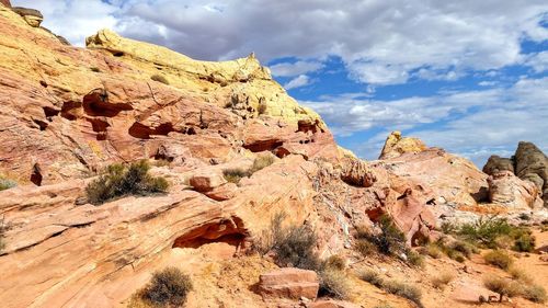 Rock formations on landscape against sky