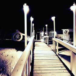 Illuminated lamp against sky at night