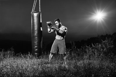 Full length of man standing on field against sky