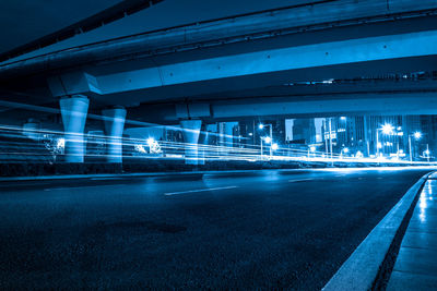 Light trails on bridge in city at night