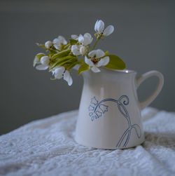 Close-up of white flower vase on table