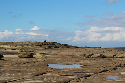 Scenic view of arid landscape against sky