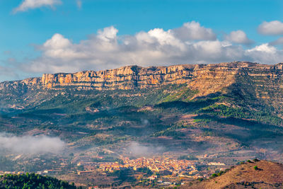 Aerial view of town against cloudy sky