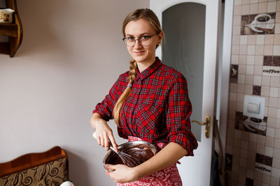 The process of mixing and preparing chocolate cupcakes by young lady