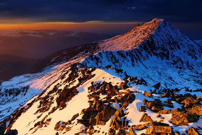 Scenic view of snowcapped mountains during sunset