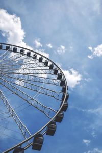 Low angle view of ferris wheel against sky