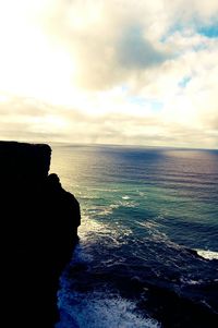 Scenic view of sea against cloudy sky