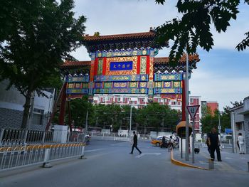 Man walking on road against buildings in city