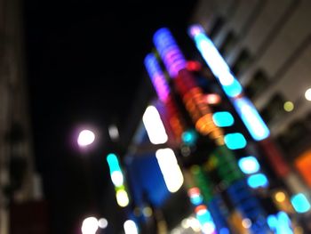 Defocused image of illuminated city at night