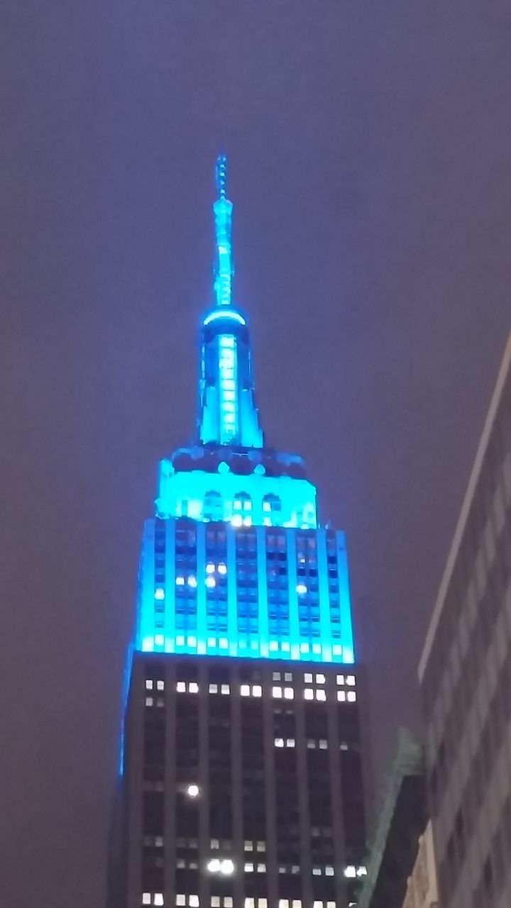 building exterior, architecture, built structure, illuminated, blue, night, city, communication, guidance, sky, tower, modern, building, lighting equipment, copy space, outdoors, low angle view, no people, tall - high, clear sky