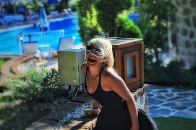 Woman standing by swimming pool