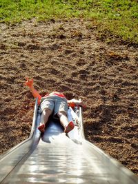 Low section of boy on slide at playground