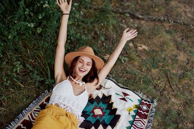 Portrait of young woman sitting on field