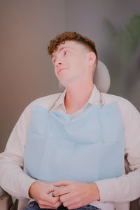 Young guy looking forward to sitting in the dental chair, cute facial expression