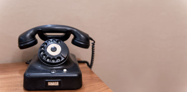 Close-up of telephone on table