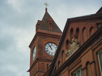 Low angle view of clock tower against sky
