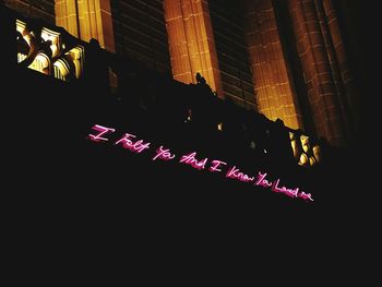 Illuminated text on building at night