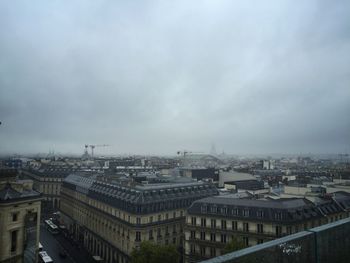 High angle view of buildings in town against sky