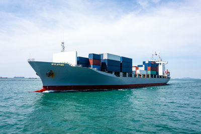 Container cargo ship carrying commercial container in import export business services 