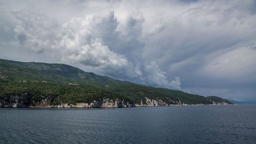 Leaving croatia's coast by ferry with approaching storm includuing part of the ferry.