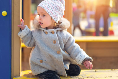 Cute girl at playground during winter