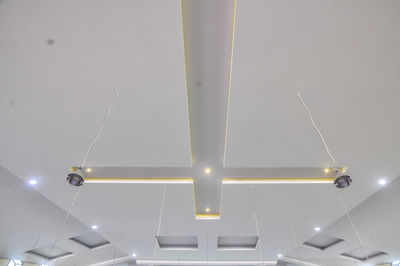 Low angle view of illuminated lights hanging from ceiling